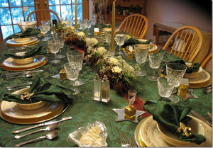 holiday table setting with green christmas tablecloth and festive tablescape