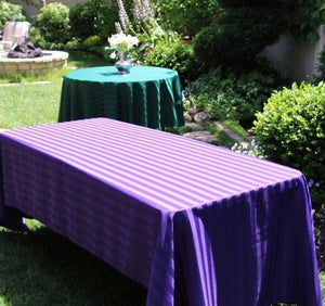 two tables lined with linens at an event