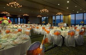 White poly premier linens on round tables in luxury wedding reception with views of mountains