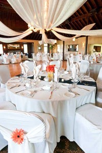 White wedding linens with on round tables at beautiful wedding