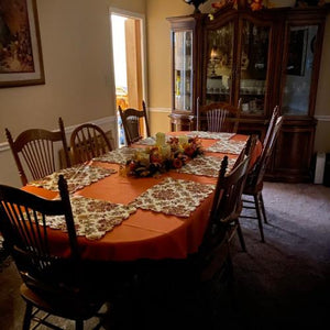 Orange oval tablecloth with fall decorations