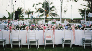 Poly Premier wedding linens on extra-long tables at a beautiful outdoor reception with flowers
