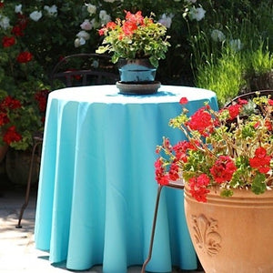 Outdoor table setting with elegant table linens and flowers