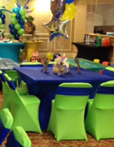 Spandex table covers and chair bands at a child's birthday party with balloons
