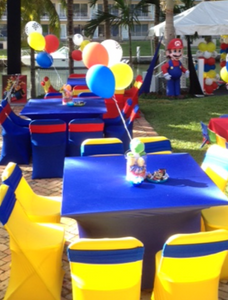 Square spandex table linens and chair bands at a child's Mario brothers themed birthday party