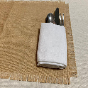 Burlap placemats with fringe over an ivory tablecloth