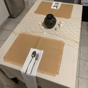 Rustic burlap placemats and napkins on a table with beach decoration