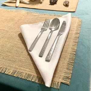 Burlap placemats with fringe on a dining room table