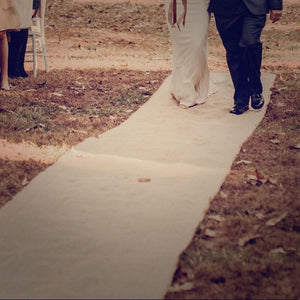 Burlap wedding aisle runner at an outdoor ceremony
