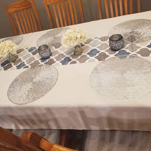 Ivory-colored fine linen on a home dining room table with a Middle Eastern-styled table runner