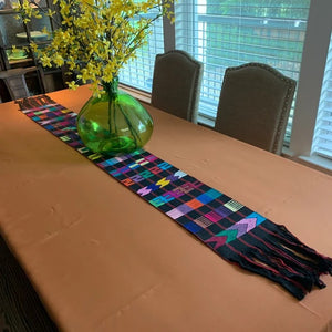 Burnt orange linens in a home setting with a bohemian-styled table runner
