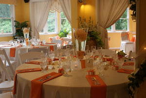 White Wedding linens with Orange napkins and flowers