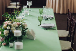 Ivory tablecloth on a wedding head table with 2 banquet chairs