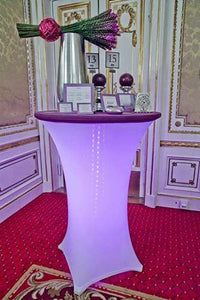 Spandex tablecloth in two colors at a high-end wedding reception with table numbers and collateral