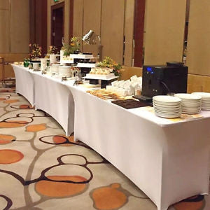 White spandex tablecloths on coffee and dessert tables during a wedding
