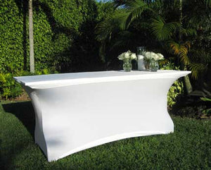 White Spandex tablecloth on an outdoor wedding table with flowers