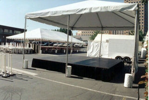 Stage skirting under a tent at an outdoor event