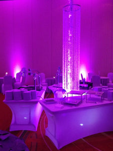 Spandex table linens in dark-themed event room with neon lights