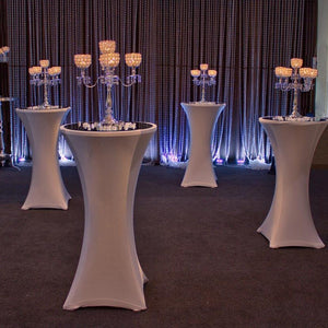 Fitted Spandex tablecloths in a high-end cocktail hour with candelabra on top