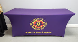 Blue 6 foot Spandex table cover with Jacksonville Fire Rescue wellness program logo printed