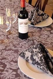 Damask tablecloth and napkins folded on plate