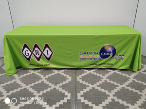 Green custom-printed tablecloth with 2 corporate logos printed left and right