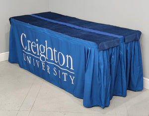Creighton University branded table skirt with white printed logo and velvet table runners