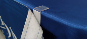 Close-up of table skirt clip on edge of a table showing velcro side