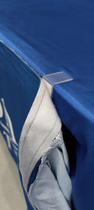 Close-up of table skirt clips on edge of a table