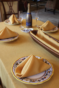 Havana napkins on desert plates in an outdoor setting with a wine bottle