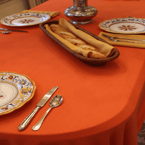 Orange oval tablecloth and cloth napkins