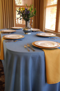 Havana tablecloth on an oval table with cloth napkins