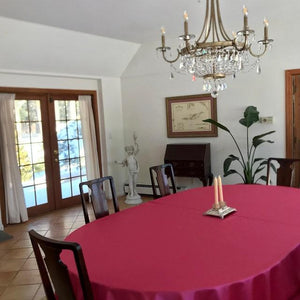 Pink Majestic oval tablecloth on a table in a beautiful home