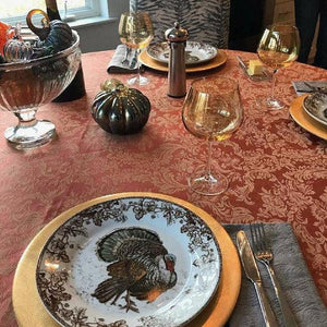 Thanksgiving tablecloth with turkey on plates and pumpkins