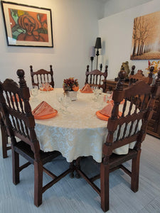 Fall tablecloth setting on an oval table with autumn decortaion on the table 