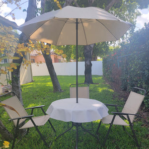 White outdoor vinyl tablecloth with umbrella hole and zipper in a back yard