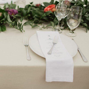 White wedding table linen with beautiful arrangement on table