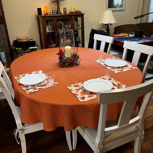 Oval burnt orange fall tablecloth setting