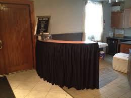 Black poly premier shirred pleat skirt on a hotel reception desk