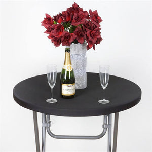  Black round fitted table cloth with vase of flowers, champagne bottle and two glasses