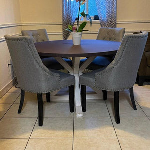 Brown round fitted tablecloth in a home, dining room table, orchids plant on table