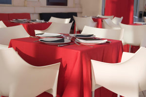Red square tablecloth with black and white napkins and plates
