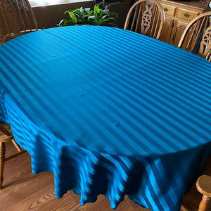 Blue oval tablecloth in a farmhouse dining room 