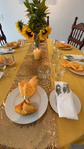 Poly Stripe yellow Oval Tablecloth with cloth napkins and a gold table runner