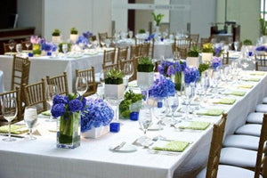 Havana Wedding linens at a large wedding reception with golden napkins and  Hydrangea Plant's