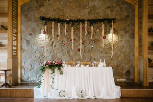 formal Havana linens in white on the head table at a wedding reception