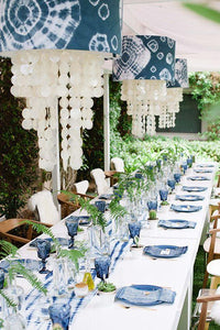 White table linen with tye dye runner, matching napkins and overhead lamps