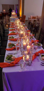 Wedding linens in a Lilac color on various tables in a wedding reception with knotted napkins