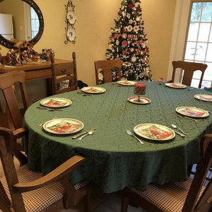 Damask tablecloth hunter green on an oval table during Christmas