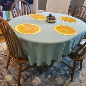 Spun Oval tablecloth with oranges placemats printed on it